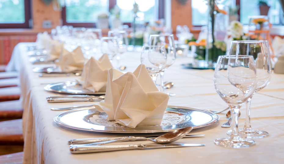 eingedeckte Tafel mit Silbertellern